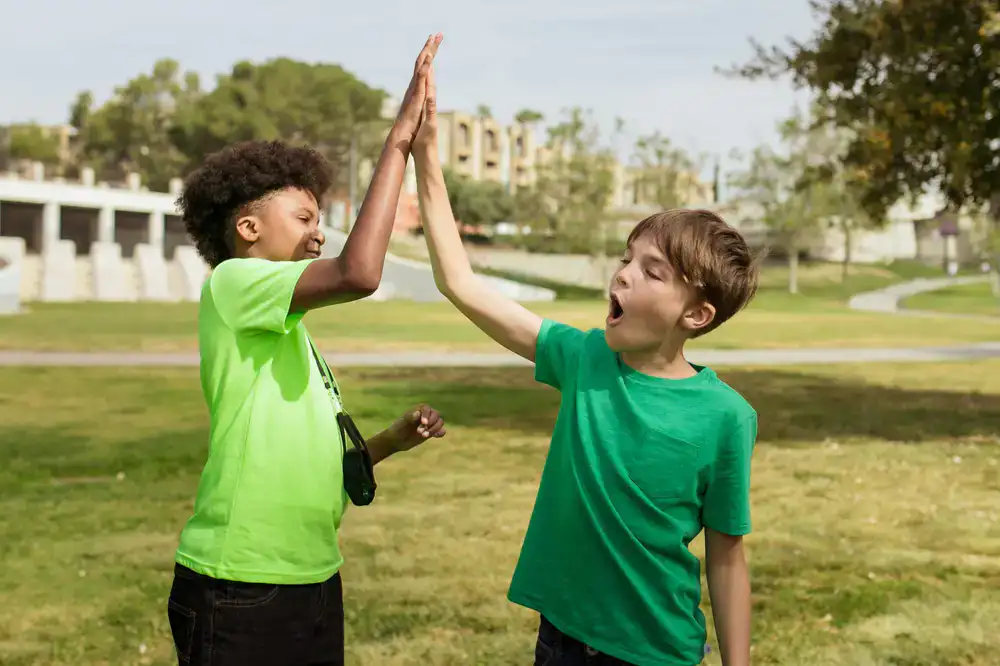 Kids high-fiving during a coding camp