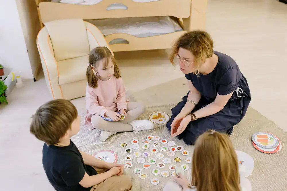Kids working together on a floor puzzle away from computers