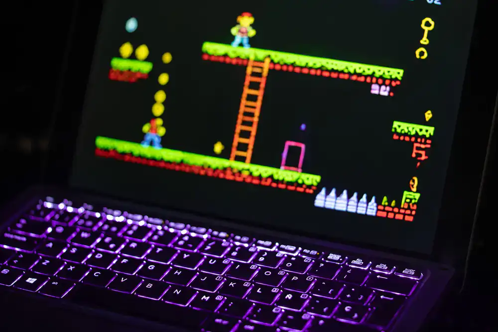 Kids designing video games on laptops